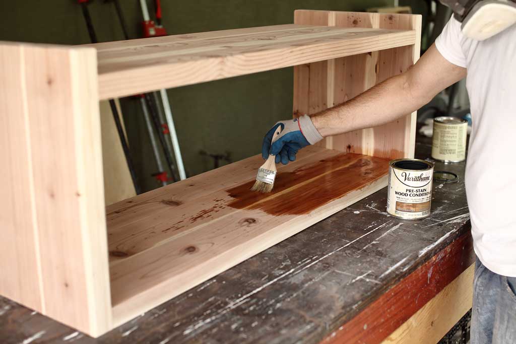 applying pre-stain on wood