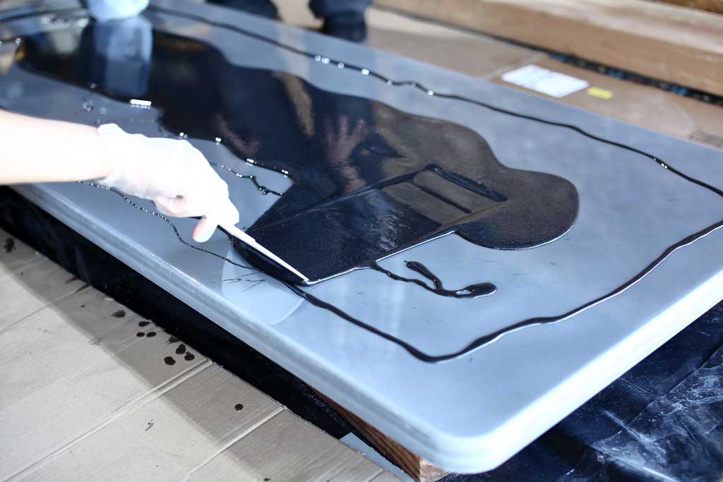 spreading epoxy on tabletop